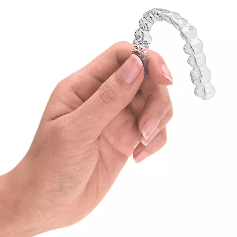 Hand Holding Invisalign Tray