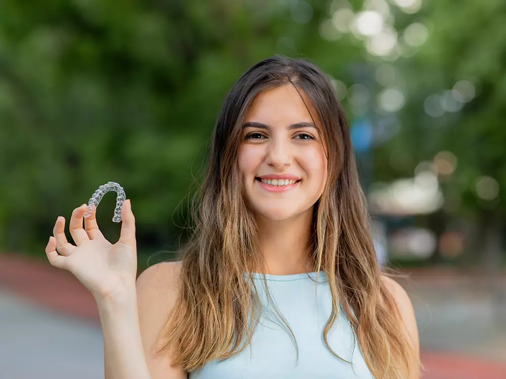 Teenage Girl Showing Invisalign Clear Aligners